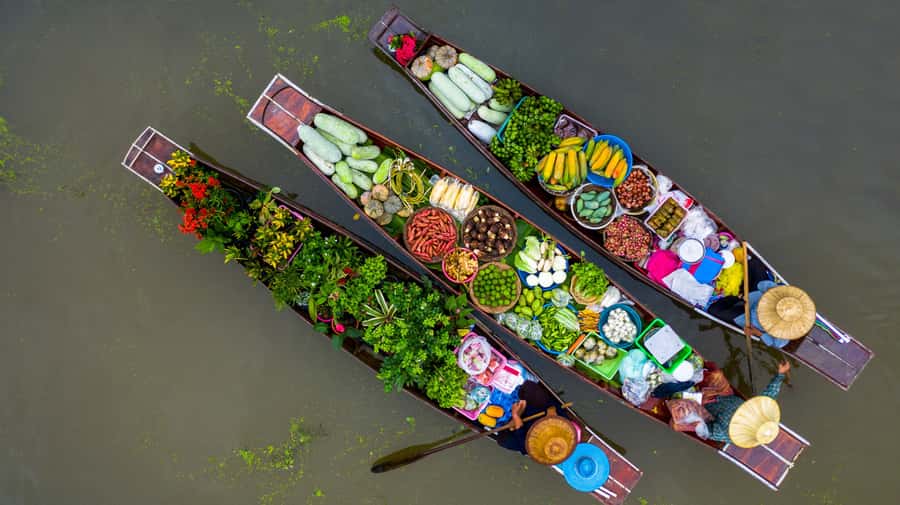 From Bangkok: Maeklong Railway and Floating Market Food Tour - Damnoen Saduak Floating Market: boat life, plus a reality check